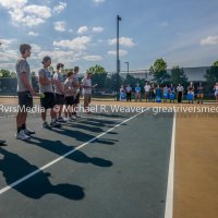 Jersey High tennis team seniors stand facing spectators as their parents wait to be recognized with their sons.