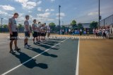 Jersey High tennis team seniors stand facing spectators as their parents wait to be recognized with their sons.
