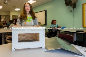 Abby Womack with her electrically lit and portable mini chicken coop.