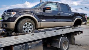 Multiple County Fugitive Chase Leaves A Path of Destruction Pickup truck stolen in Kampsville used by fleeing suspect is on tow truck showing major damage after multiple county chase.