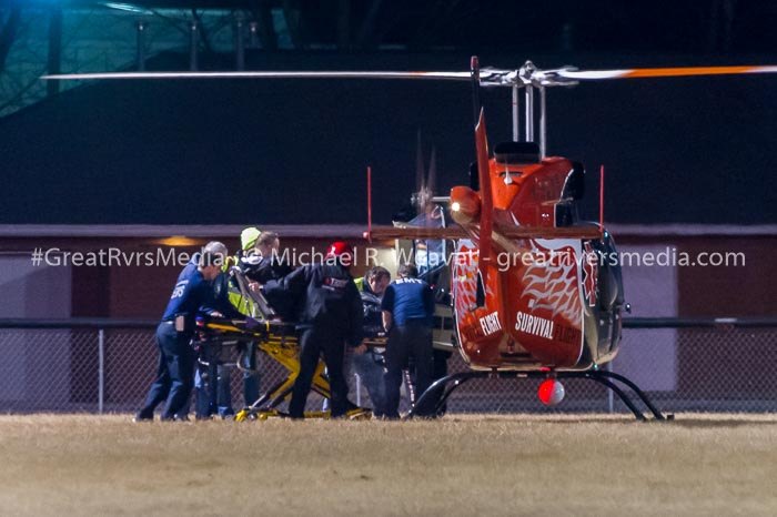 Game official being placed aboard a Survival Flight helicopter at the Calhoun High football field. The time delay between the onset of symptoms to leaving the football field was approximately 52 minutes despite several ambulances on site within minutes.