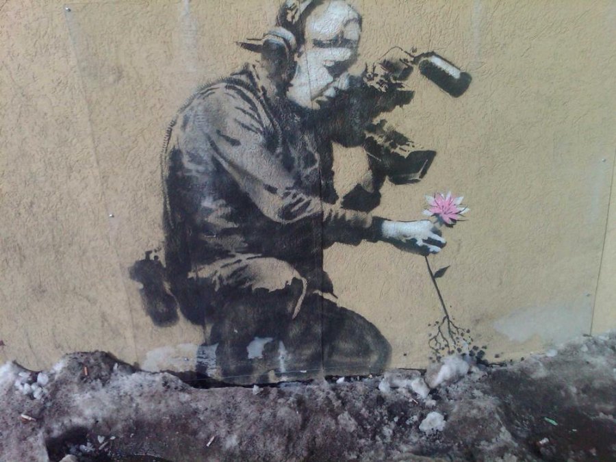 “Camera Man and Flower” by Banksy. Stencil on concrete. 2010.