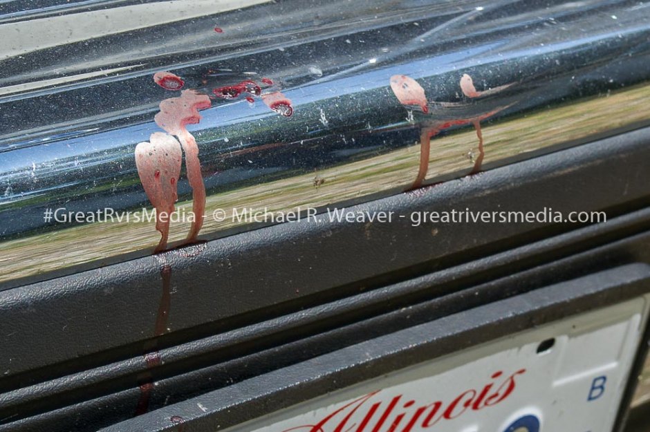 Blood remains on the bumper of local resident's vehicle from shooting that left suspect dead and officer wounded.