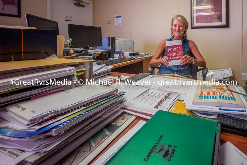 Carrollton IL. Superintendent of Schools Kerry Cox in her office with her latest read.
