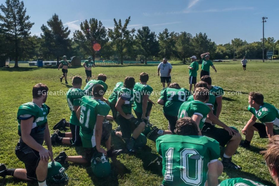 Carrollton player was told if he could beat last person in from mile run that Coach Flowers would do ten pushups. This is the scene immediately before Coach Flowers hit the ground to do them.