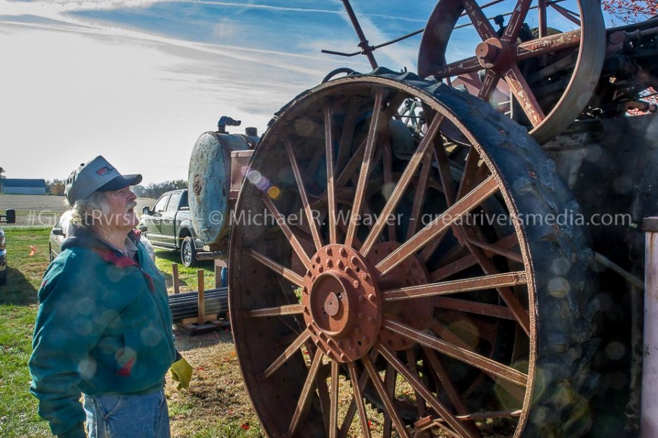 Hazel Dell Auction Sells Rare Farm Equipment Auction attendee examines Reeves steam Traction engine before auction begins.